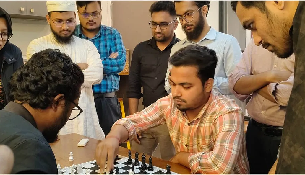 6sense HQ teammates playing chess in the office play zone