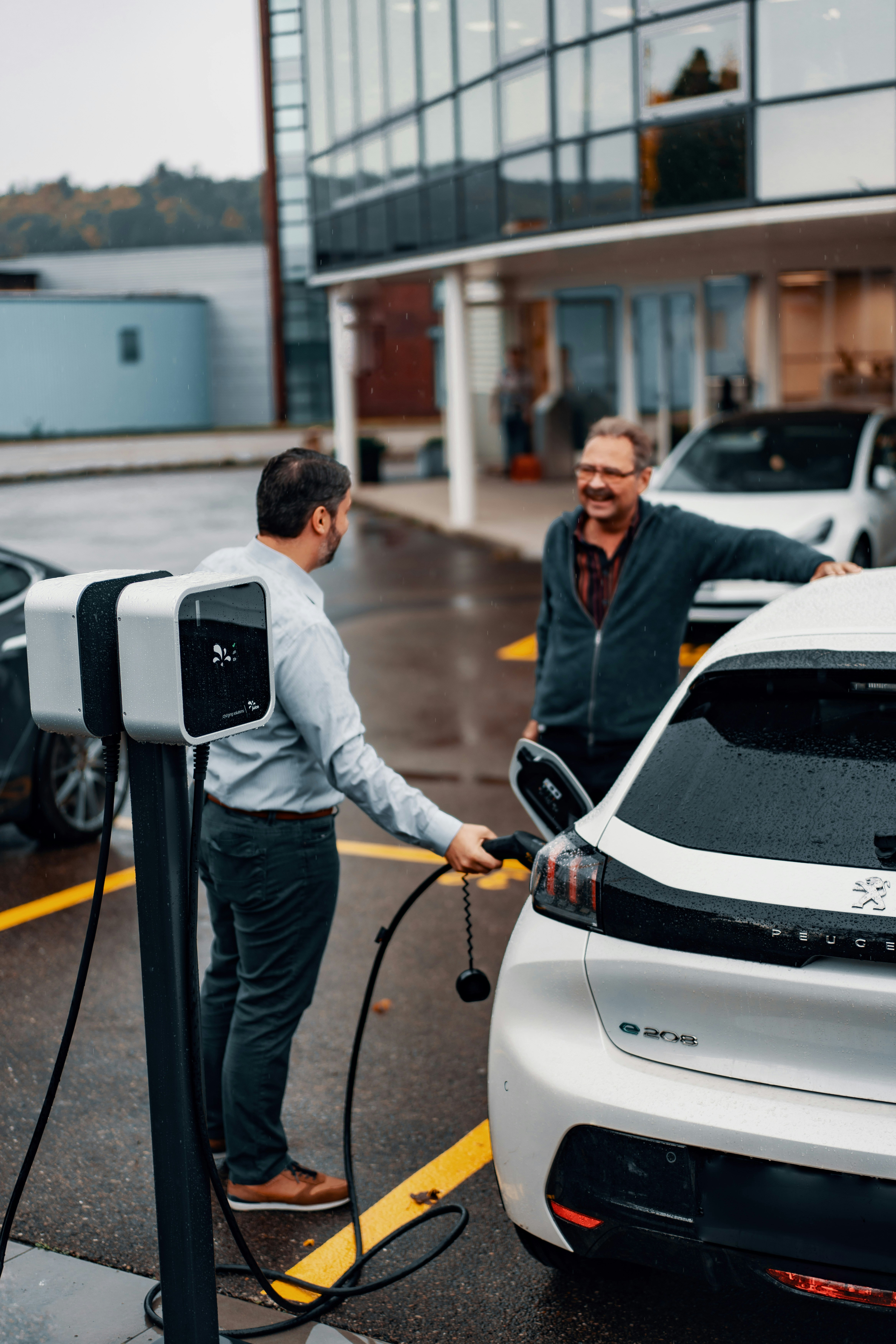 Person charging an electric vehicle