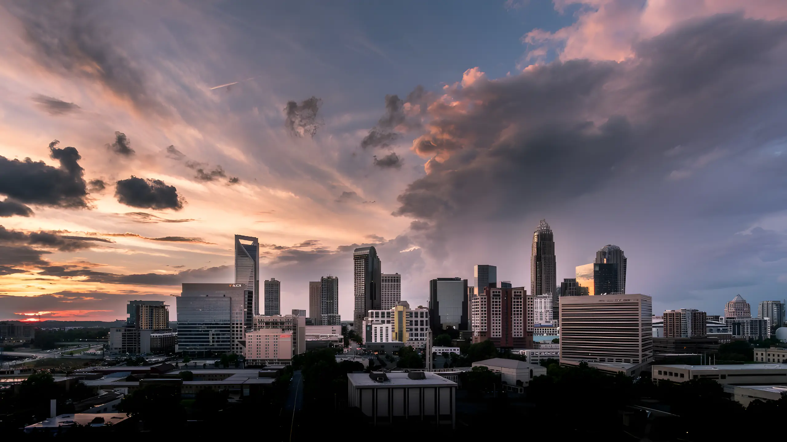 Charlotte city skyline under dramatic sunset clouds